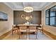 Elegant dining room with coffered ceilings, modern chandelier, and large window at 153 W Beech Slope Ct, Chapel Hill, NC 27517