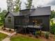 The rear exterior of the home showcases a deck and screened in porch, perfect for outdoor living and entertaining at 153 W Beech Slope Ct, Chapel Hill, NC 27517
