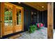 Inviting front porch features double doors, a charming swing, and stone flooring at 153 W Beech Slope Ct, Chapel Hill, NC 27517