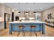 Spacious kitchen with a large island, modern lighting, and stainless steel appliances at 153 W Beech Slope Ct, Chapel Hill, NC 27517