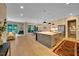 Open-concept kitchen with stainless steel appliances, island with bar seating, and hardwood floors at 153 W Beech Slope Ct, Chapel Hill, NC 27517