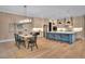 Elegant kitchen and dining area with a large island, pendant lights, and dining table set at 153 W Beech Slope Ct, Chapel Hill, NC 27517