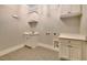 Practical laundry room with white cabinetry, a sink, and ample counter space at 153 W Beech Slope Ct, Chapel Hill, NC 27517