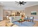 Inviting living room flows into open kitchen, featuring modern furnishings and hardwood floors at 153 W Beech Slope Ct, Chapel Hill, NC 27517