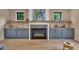 Cozy living room with a fireplace, built-in shelves, and stylish decor at 153 W Beech Slope Ct, Chapel Hill, NC 27517
