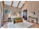 Bright main bedroom with wood beams, natural light, and barn door to en suite at 153 W Beech Slope Ct, Chapel Hill, NC 27517