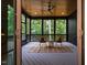 Relax on this covered porch featuring comfortable seating and a ceiling fan for ultimate outdoor enjoyment at 153 W Beech Slope Ct, Chapel Hill, NC 27517
