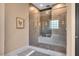Walk-in shower featuring glass doors, neutral tiling, and shower head at 153 W Beech Slope Ct, Chapel Hill, NC 27517