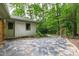 Tranquil backyard featuring a stone patio area leading to a swing, enhanced by lush landscaping at 1606 Sycamore St, Durham, NC 27707