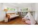 Charming bedroom featuring built-in shelving, hardwood floors, and playful teepee decor at 1606 Sycamore St, Durham, NC 27707