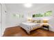 Serene bedroom showcasing hardwood floors, natural light from the windows, and neutral decor at 1606 Sycamore St, Durham, NC 27707