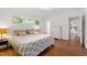 Bright bedroom features hardwood floors, natural light, and a view into an adjacent ' playroom at 1606 Sycamore St, Durham, NC 27707