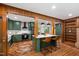 Open-concept kitchen with a marble island, eat-in counter, herringbone floors, and modern appliances at 1606 Sycamore St, Durham, NC 27707