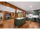 Spacious open kitchen with herringbone floors, a marble island, and stylish dark green cabinetry at 1606 Sycamore St, Durham, NC 27707