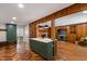 Open living room with hardwood herringbone floors, a kitchen island, and a built-in bar area at 1606 Sycamore St, Durham, NC 27707