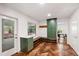 Functional mud room includes built-in seating, storage cabinets, herringbone floors, and exterior access at 1606 Sycamore St, Durham, NC 27707