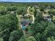 Lush greenery surrounds a home with a private pool, deck, and long driveway, offering a serene retreat at 171 St. Jiles Dr, Clayton, NC 27520