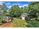 A charming backyard featuring a pool with black fencing, a storage shed, and lush green grass at 171 St. Jiles Dr, Clayton, NC 27520