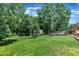 A spacious backyard with lush greenery, featuring an in-ground pool, a shed, and lawn chairs at 171 St. Jiles Dr, Clayton, NC 27520