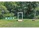 Charming backyard with whimsical bridge and archway, highlighted by bright blue Adirondack chairs against lush greenery at 171 St. Jiles Dr, Clayton, NC 27520