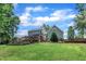 Lush backyard with fenced pool, spacious deck, and mature trees providing a serene outdoor space for leisure and entertainment at 171 St. Jiles Dr, Clayton, NC 27520
