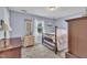 Traditional bedroom with a four-poster bed, area rug, and bright natural light from the window at 171 St. Jiles Dr, Clayton, NC 27520