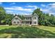 Attractive two-story home with a charming front porch, well-maintained lawn, and mature trees in a peaceful neighborhood at 171 St. Jiles Dr, Clayton, NC 27520