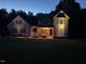 Charming two-story home at dusk with a welcoming porch, well-lit facade, and manicured landscaping at 171 St. Jiles Dr, Clayton, NC 27520