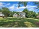 Inviting two-story home with a charming front porch, lush greenery, and a well-maintained lawn in a tranquil setting at 171 St. Jiles Dr, Clayton, NC 27520