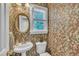 Charming half bathroom with patterned wallpaper, a pedestal sink, and a window offering natural light at 171 St. Jiles Dr, Clayton, NC 27520