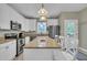Modern kitchen featuring granite countertops, stainless steel appliances, an island with seating, and bright lighting at 171 St. Jiles Dr, Clayton, NC 27520