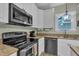 A closer view of the kitchen showcasing stainless steel appliances and granite countertops, plus bright, natural light at 171 St. Jiles Dr, Clayton, NC 27520