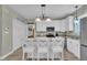 Updated kitchen with an island, white cabinetry, stainless appliances, and modern fixtures for culinary enthusiasts at 171 St. Jiles Dr, Clayton, NC 27520