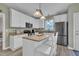 Well-equipped kitchen features an island with seating, stainless steel appliances, and ample cabinet space at 171 St. Jiles Dr, Clayton, NC 27520
