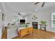 Cozy living room featuring hardwood floors, a fireplace, ceiling fans and ample natural light at 171 St. Jiles Dr, Clayton, NC 27520