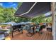 Spacious back deck featuring an outdoor kitchen with grill, seating area, and retractable awning at 171 St. Jiles Dr, Clayton, NC 27520