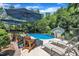 Sparkling in-ground pool is surrounded by lounge chairs and umbrellas, creating a perfect backyard oasis for relaxation at 171 St. Jiles Dr, Clayton, NC 27520