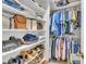 Well-organized walk-in closet with shelves and hanging racks filled with clothes and accessories at 171 St. Jiles Dr, Clayton, NC 27520