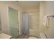 This full bathroom has a shower/tub combo with a blue and white shower curtain and updated fixtures at 1848 Glenn St, Burlington, NC 27217