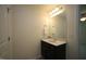 The bathroom features a dark vanity, framed mirror, vanity lighting, and neutral paint at 1848 Glenn St, Burlington, NC 27217