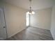 The dining room has new light fixture and wood-look floors next to a glass patio door at 1848 Glenn St, Burlington, NC 27217