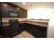 Modern kitchen featuring dark cabinets, black appliances, and sleek countertops at 1848 Glenn St, Burlington, NC 27217