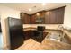 Kitchen with modern black appliances, dark wood cabinets, and stylish countertops at 1848 Glenn St, Burlington, NC 27217
