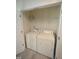 Compact laundry closet equipped with a white washer and dryer at 1848 Glenn St, Burlington, NC 27217