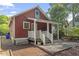 Beautiful backyard features a charming red house and a small garden at 1916 Hart St, Durham, NC 27703
