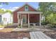 Quaint red house features a covered porch and a backyard garden at 1916 Hart St, Durham, NC 27703