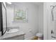 Well-lit bathroom with granite countertops, updated fixtures, and walk-in shower at 1916 Hart St, Durham, NC 27703