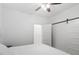 Bright bedroom features a ceiling fan and a white sliding barn door at 1916 Hart St, Durham, NC 27703