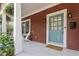 Inviting front porch with blue door, white columns, and seating area at 1916 Hart St, Durham, NC 27703