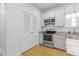 Bright kitchen with stainless steel appliances, granite countertops, and stainless steel farmhouse sink at 1916 Hart St, Durham, NC 27703